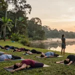 200 hour yoga teacher training sri lanka group practicing yoga at sunrise by Koggala Lake
